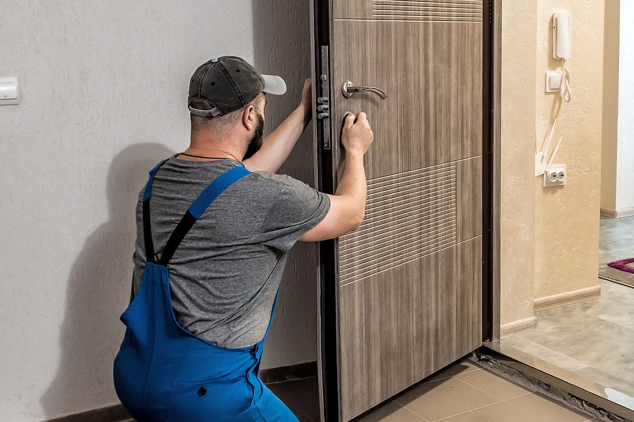 worker installing door hardware